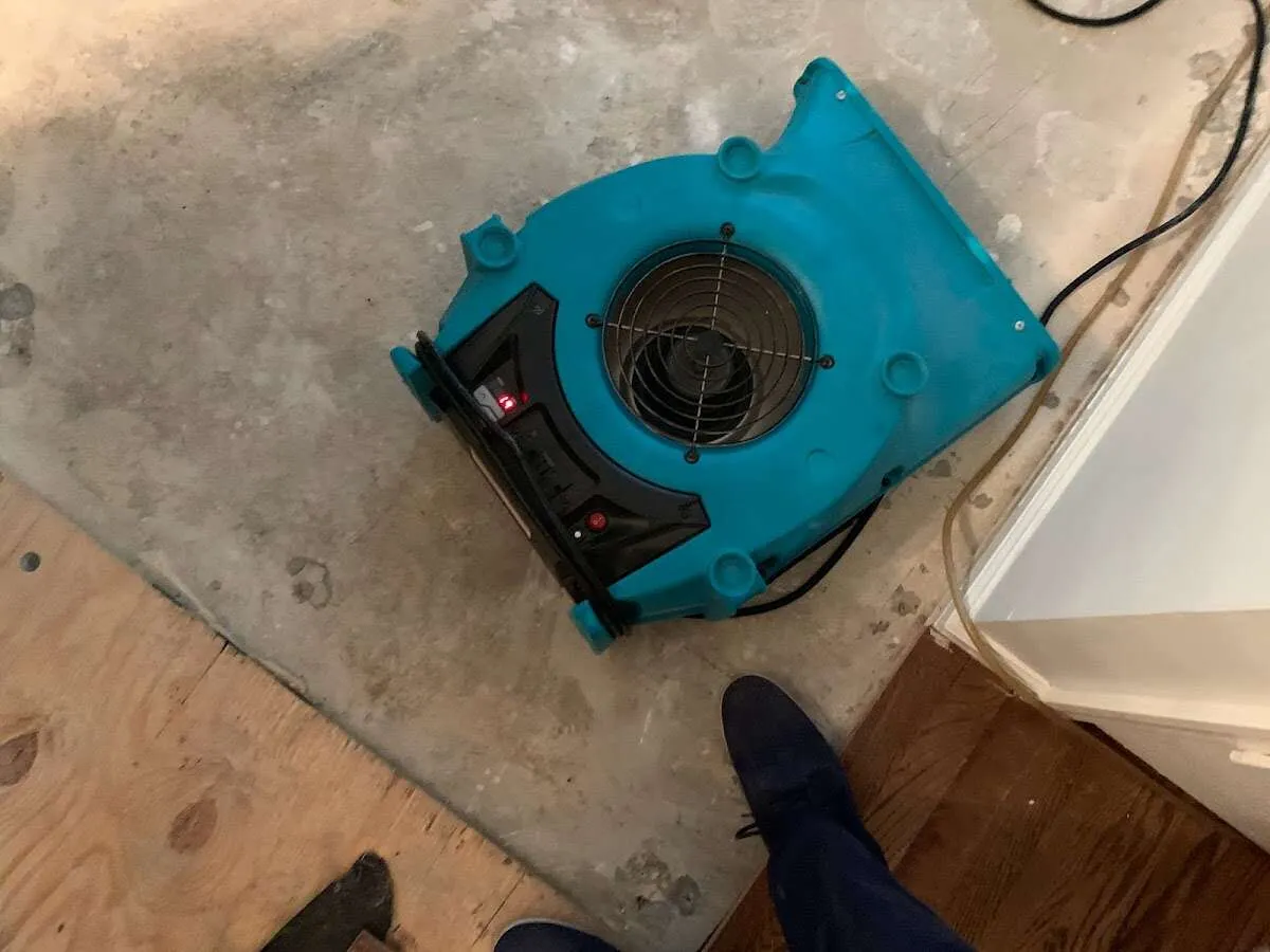 Air mover drying subfloor during Commercial Water Damage Restoration in Biddeford